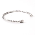 Close-up of silver twisted wire open bangle with cylindrical end caps and industrial design - Steel Color (Silver)