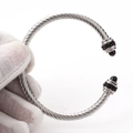 Macro detail of twisted cable stainless steel bracelet with black beads and diamond accents - Steel Black Zircon/Black Agate Bead