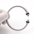 Macro detail of silver twisted cable bracelet featuring black crystal pavé end caps - Steel Black Zircon/Steel Bead