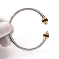 Macro detail of twisted cable steel bangle featuring black stones and gold-toned accents - Gold-Silver Black Zircon/Steel Bead