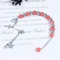 Detailed close-up of pink crystal bead bracelet with silver cross and heart charms - Silver Chain Red Blast Bead