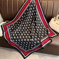 Detail of geometric pattern square silk scarf on leather sofa with luxury accessories - 90x90cm / Red