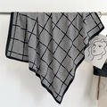 Detail of classic black and white houndstooth silk scarf with elegant drape and texture - 90x90cm / Black and White