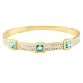 Gold plated stainless steel hinged bracelet featuring square blue zircon gemstones - Gold Blue Zirconia