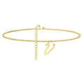 Macro detail of cursive letter V pendant on golden stainless steel anklet chain - Letter V