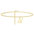Macro detail of golden stainless steel ankle chain featuring a cursive letter U pendant - Letter U