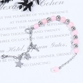 Pink crystal beaded bracelet with silver cross and heart charms on white card - Silver Chain Pink Bead