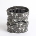 Detail of grey knitted winter neck warmer showing soft thick plush lining and bear pattern - Gray