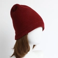 Close-up of dark red knitted beanie featuring fine stitch texture and ribbed edge - One Size / Dark Red