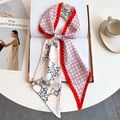 Elegant floral satin twilly scarf with horsebit print on an open magazine book - Red Pink White Horsebit Chain (LE-252)