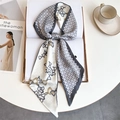 Detail of printed silk-like twilly scarf with chain pattern on a fashion magazine - Grey White Patchwork Chain Horsebit (LE-254)