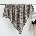 Close-up of geometric G-pattern printed silk scarf draped on a metal hanger - 90x90cm / Gray Brown (FN169-2)