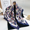 Floral print silk scarf with navy border and pink blossoms on a wooden hanger - 90x90cm / Navy Blue