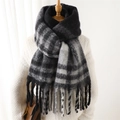 Close-up of thick plaid cashmere-feel scarf with tassels on a mannequin - Black (WT125-7)