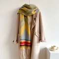 Close-up of thick winter scarf with vibrant color-block pattern and long tassels - Bright Yellow