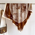 Macro detail of starry galaxy print silk scarf with vintage astronomical moon patterns - Coffee