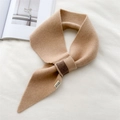 Detail of camel knitted scarf with cross-loop design and a minimalist woven tag - Khaki