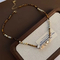 Macro view of tiger eye stones and iridescent mother of pearl on a beaded necklace - Tiger Eye Mother of Pearl Patchwork Style (03-M16)