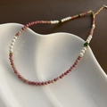 Macro detail of handmade strawberry quartz beaded necklace with pearls on ceramic tray - Pink Artificial Pearl Style (03-E15)