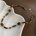 Vintage necklace with natural tiger eye beads and freshwater pearls on white display - Barrel Bead Tiger Eye Vintage Necklace (4)