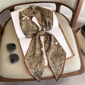 Stylishly tied paisley print thin scarf on a white book with sunglasses accessory - Brown Vintage Paisley Print (LE-111)