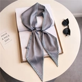 Grey houndstooth silk scarf with long narrow ribbon design displayed on a white book - Gray with Blue & White Houndstooth Edge (LE-123)