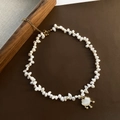 Luxury baroque pearl necklace with a shell lock pendant on dark leather surface - Pingan Lock Baroque Pearl Necklace (04-H18)