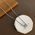Silver paperclip pendant necklace with sparkling pavé zircon stones on an elegant display - Silver