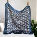 Navy blue paisley silk scarf styled with a white handbag and lush green plants - 70x70cm / Dark Blue