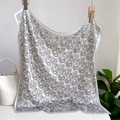 Detail of white paisley silk scarf with butterfly pattern hanging next to a bucket bag - 70x70cm / Pearl White