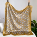 Detailed macro view of ginger yellow paisley silk scarf with elegant vintage patterns - 70x70cm / Ginger Yellow