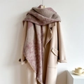 Thick beige knit scarf with purple patterns and fringe tassels on a wool coat - Lotus root pink
