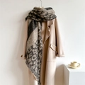 Macro detail of thick leopard print scarf with fringe edges on beige wool coat - Grey Black