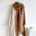 Close-up of leopard print scarf with fringe edges paired with a beige winter wool coat - Leopard Print
