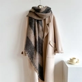 Close-up of thick checkered scarf with frayed edges paired with a beige wool coat - 250x42cm / Camel Black