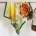 Close-up of floral silk scarf with green borders hanging beside a leather handbag - Dark Green Border Multicolor Poppy (FV5-3)