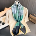 Detail of 110cm floral silk scarf with vibrant blue patterns draped over beige knit top - Dark Green Floral with Yellow Border(FE170-2)
