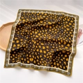 Detail of leopard print silk scarf with houndstooth border on a wooden tray - Ginger Leopard Patchwork Houndstooth Style (FR36-1)