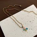 Golden butterfly necklace with multi-color oil drip pendant and beads on white stone - Three-Color Butterfly Gold Bead Chain (01-I15)