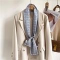 Blue silk scarf with gold chain print styled on a beige blazer with a leather bag - Light Blue Horsebit Print (LJ21-H178)