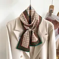 Elegant silk skinny scarf with horse chain print styled on a white blazer collar - Dark Green Red Dotted Border Print (LJ21-H180)