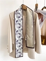 Detailed view of a double-sided floral and letter print silk scarf on a beige suit - Purple Grey Complex Floral (LJ21-H128)