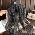 Detail of rose pattern scarf in black and white sheer fabric on an elegant clothes hanger - Black Base White Flowers (YRS32-2)