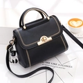 Black leather handbag with gold embroidery, metal handle, and teddy bear charm accessory - Black