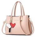 Pink lychee texture handbag with double handles and a cute red heart charm detail - Pink