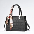 Elegant black crocodile pattern handbag with decorative silk scarf and long shoulder strap - Black