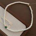 Elegant French style glass pearl necklace with a single green accent bead on a wooden tray - Titanium Steel Glass Pearl Necklace (1-7#19) / White With Green Bead