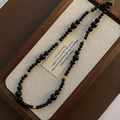 Elegant black onyx beaded necklace with gold hollow spacers on a classic wooden tray - Titanium Steel Black Agate Style (03-N15)