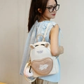 Mini cream rabbit backpack with cute ears and heart pocket on a female model - Small / Khaki