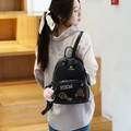 Mini black cartoon bear backpack for women featuring stylish patches and a fuzzy pompom - S / Black